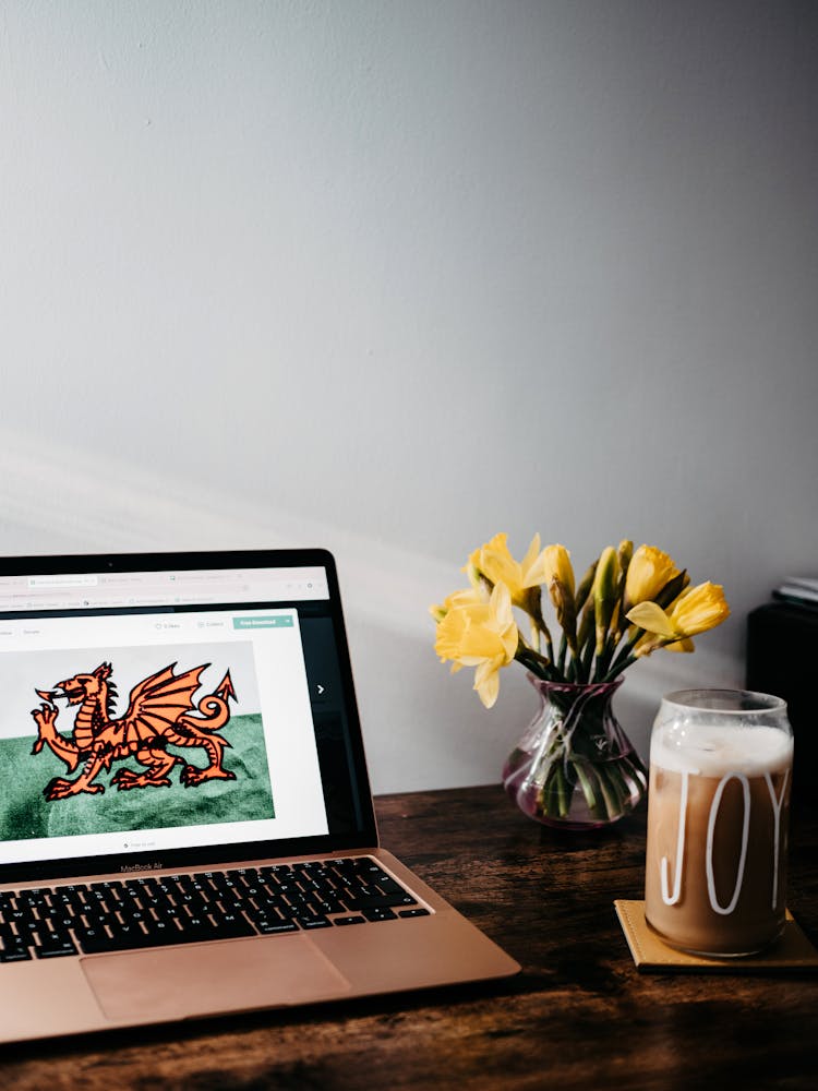 Laptop On The Table With Heraldic Symbol Of Wales 