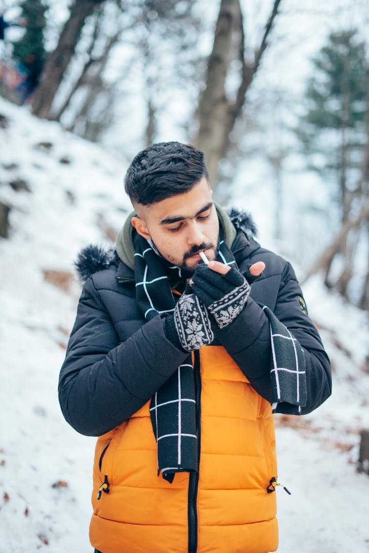 A Man Lighting A Cigarette