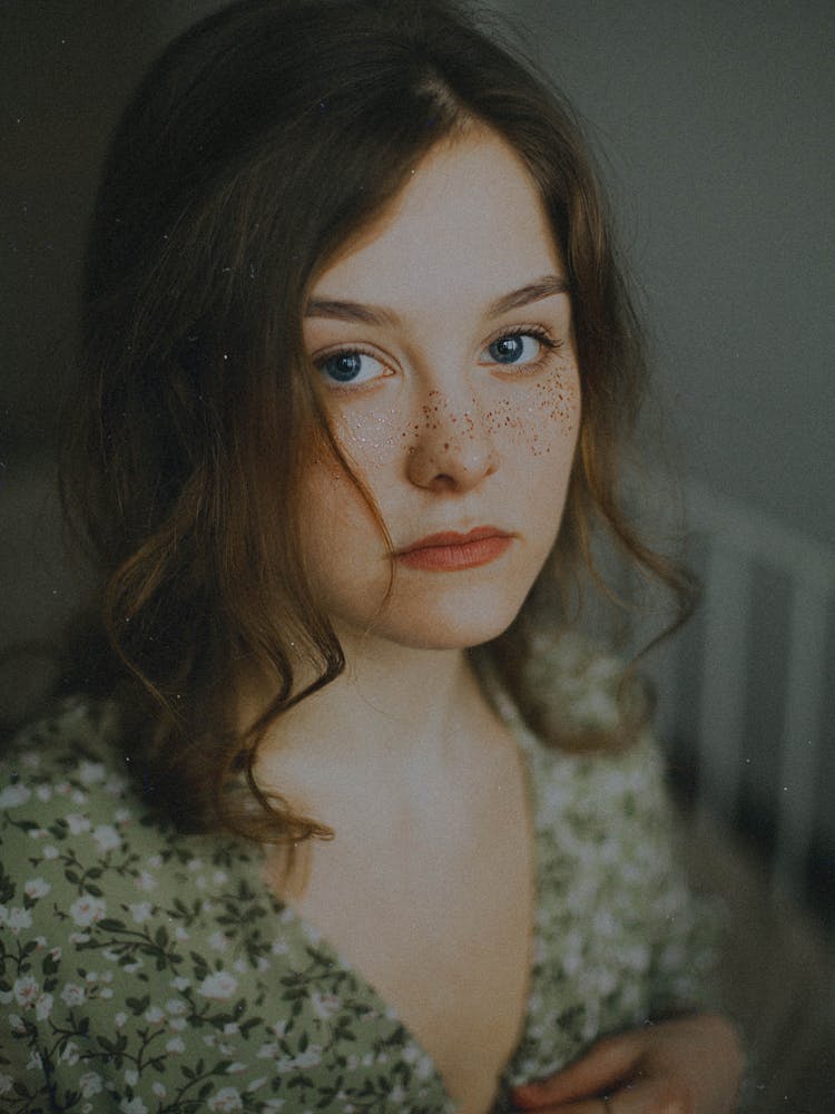 Teenage Girl With Freckled Face In Green Flowery Dress