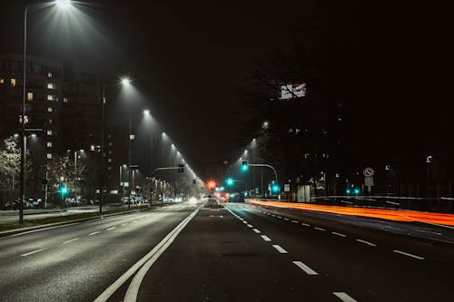 Asphalt Road with Street Lights During Night Time