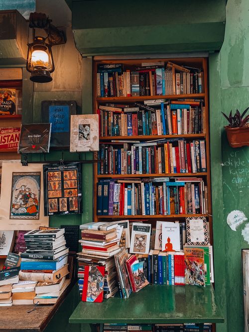 Free Discover a colorful bookshelf in a cozy Istanbul bookstore filled with a variety of books and artwork. Stock Photo