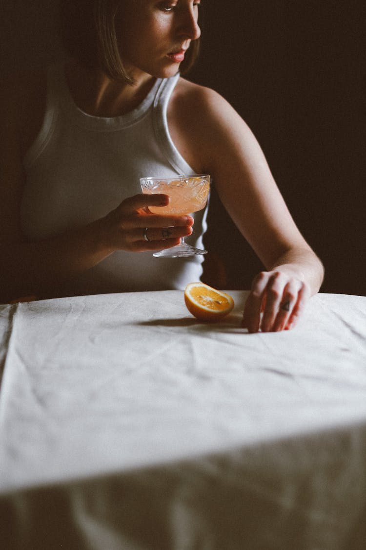 Woman Holding Glass With Orange Drink