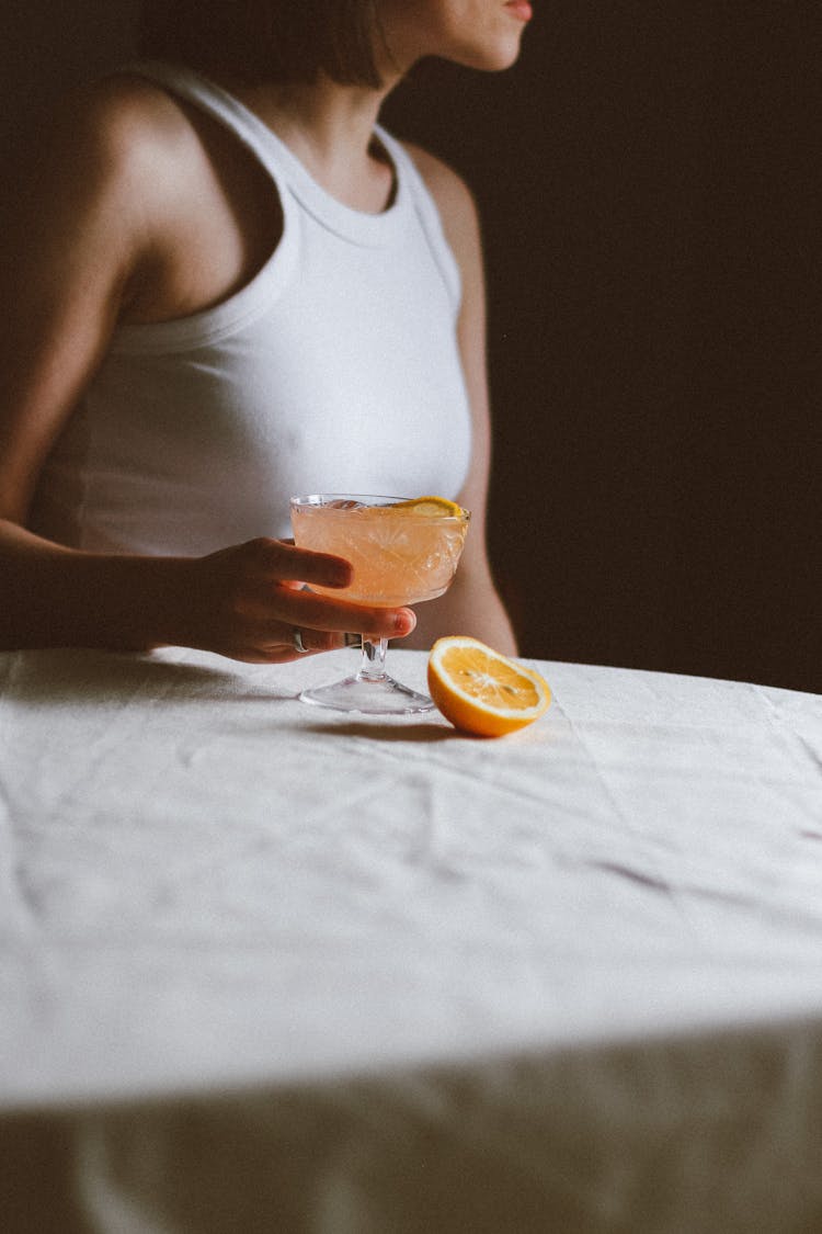 Woman Holding Glass With Orange Drink