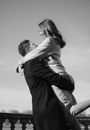 Man Holding Young Woman Aloft