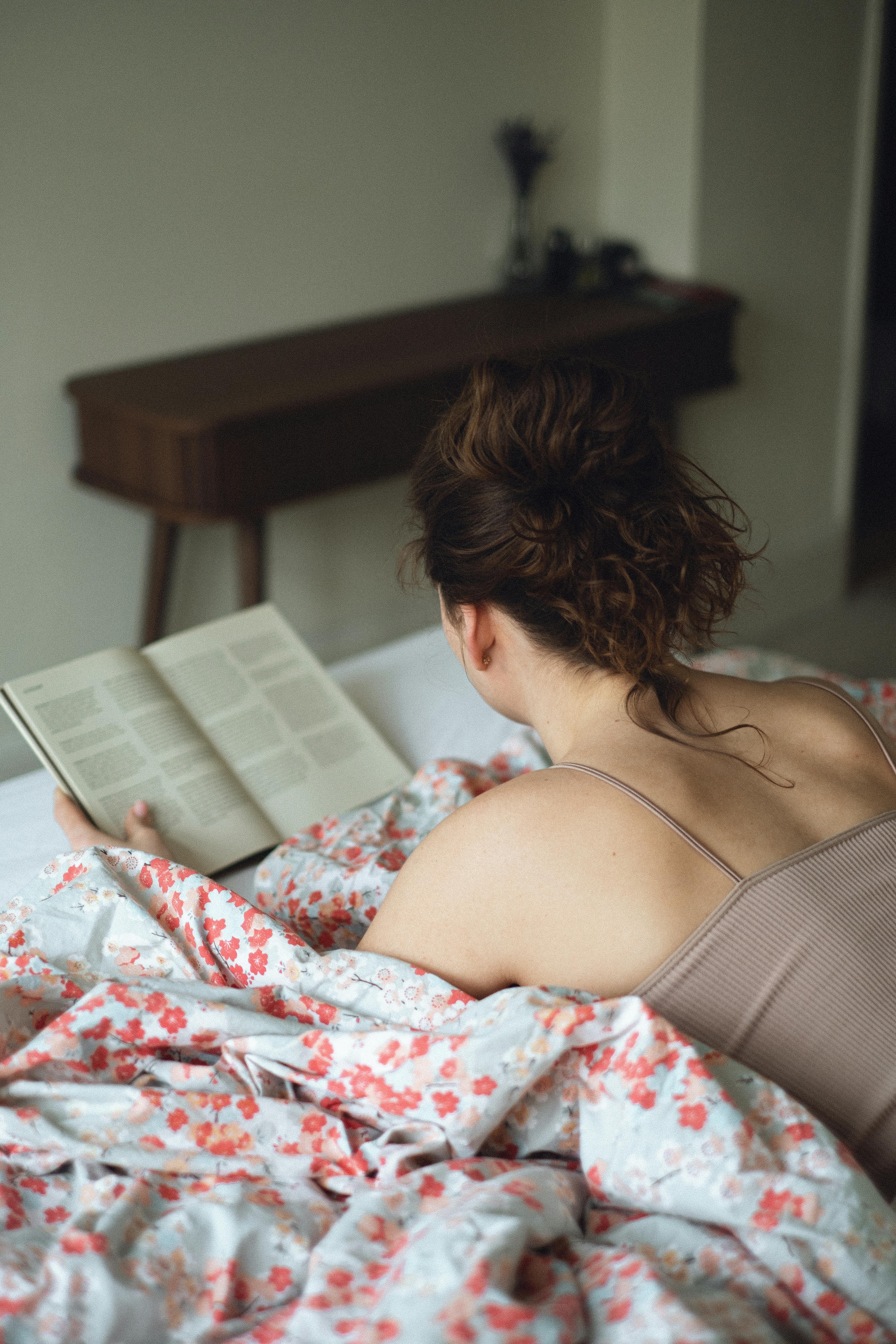back view of a woman reading a book