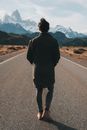 Man in Black Jacket Standing on Road
