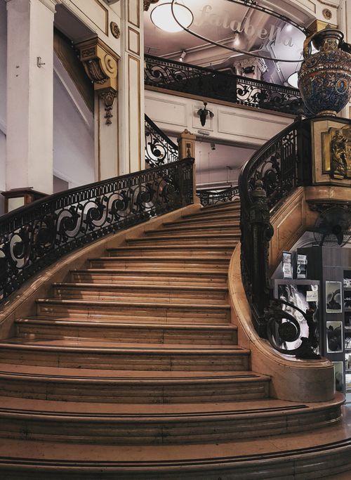 Free A beautifully designed classic spiral staircase with ornate railings in an elegant interior space. Stock Photo