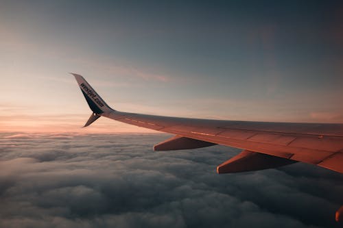 An Airplane Wing Above Thick Clouds