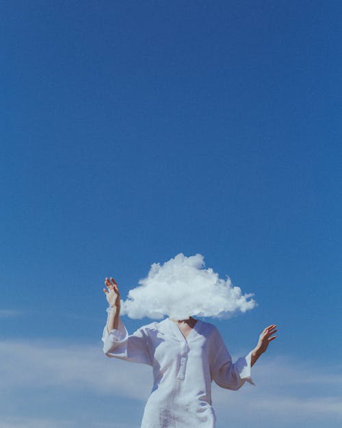 Unrecognizable Woman Covered by White Cloud