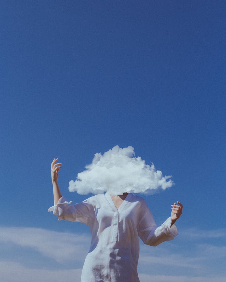 Head In Cloud With Blue Sky In Background