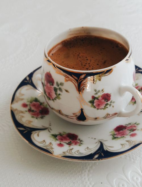 Free A close-up of traditional Turkish coffee served in an ornately decorated floral cup and saucer. Stock Photo
