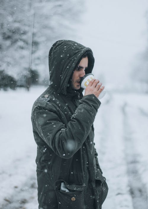 Man in Winter Jacket Drinking Coffee