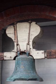 Close-up of an antique church bell in Imus, showcasing historical craftsmanship.