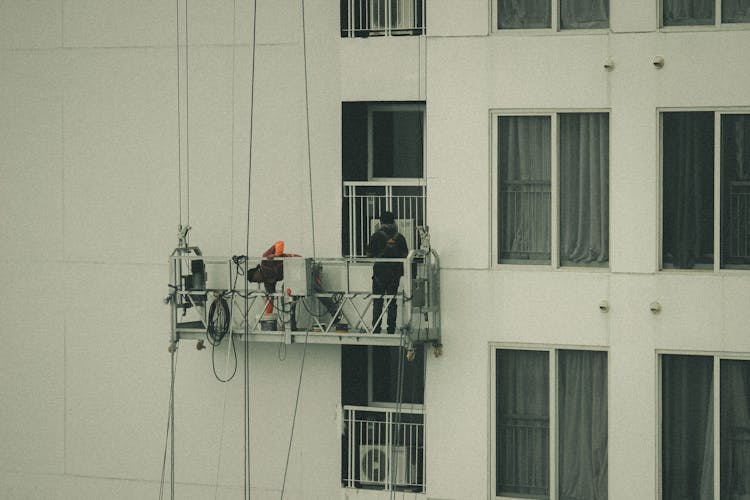 Service Workers On Building Facade