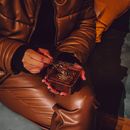 Person in Brown Leather Jacket Holding Brown Leather Bag