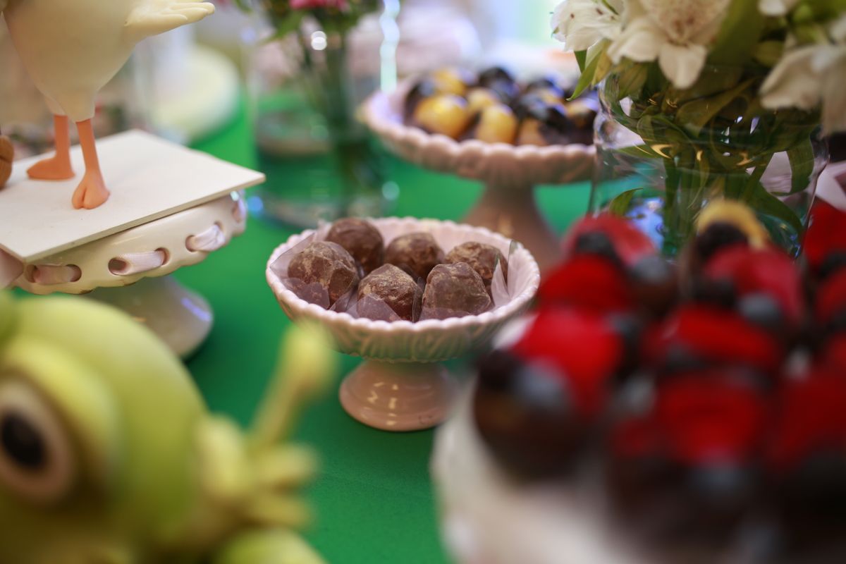 Close-up of assorted sweets on elegant pedestal stands at a party setting.