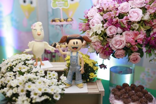 Free Whimsical toys and vibrant floral arrangement on display at a decorative exhibition. Stock Photo