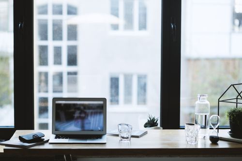 Desk by a window — photo by EVG Kowalievska on Pexels