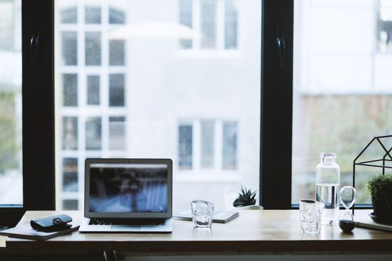 Laptop and monitor on a wooden desk — photo by EVG Kowalievska on Pexels