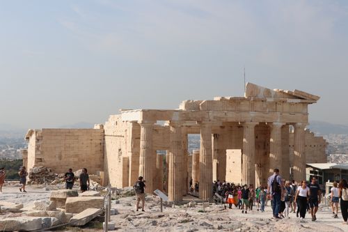 Free Visitors exploring the historic Propylaea in Athens, a classical Greek architectural marvel. Stock Photo