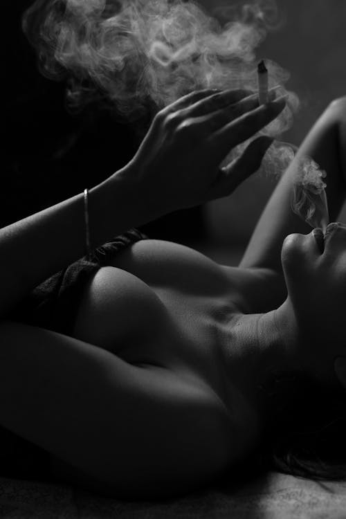 Free Grayscale Photo of a Sexy Woman Smoking Cigarette Stock Photo