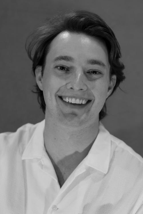 Grayscale Photo of a Man in White Polo Shirt