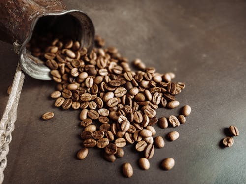 Coffee Beans Spilled on Gray Surface