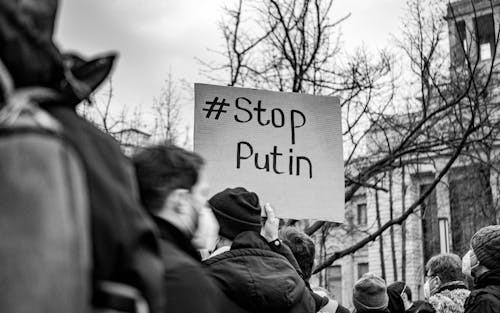 Protester holding sign with "stop putin" on it