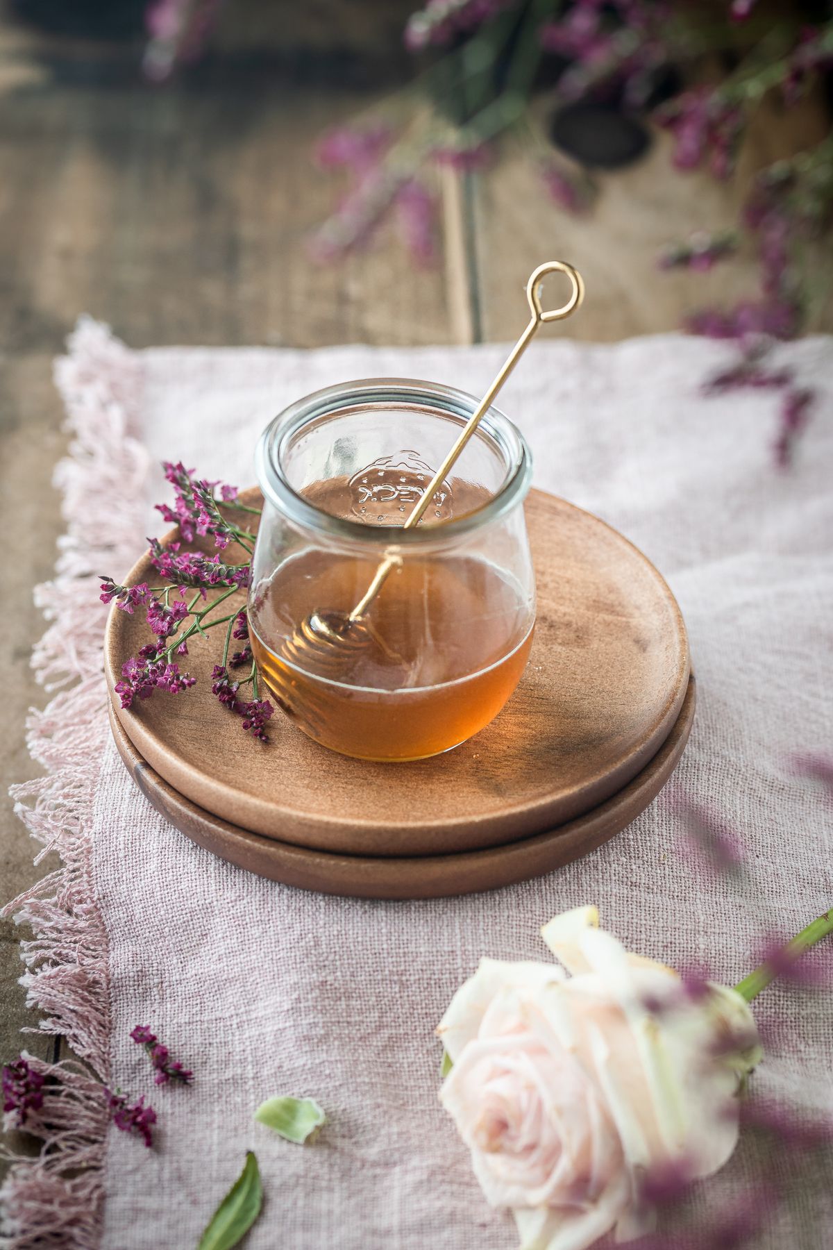 Natural honey in a glass jar with wildflowers