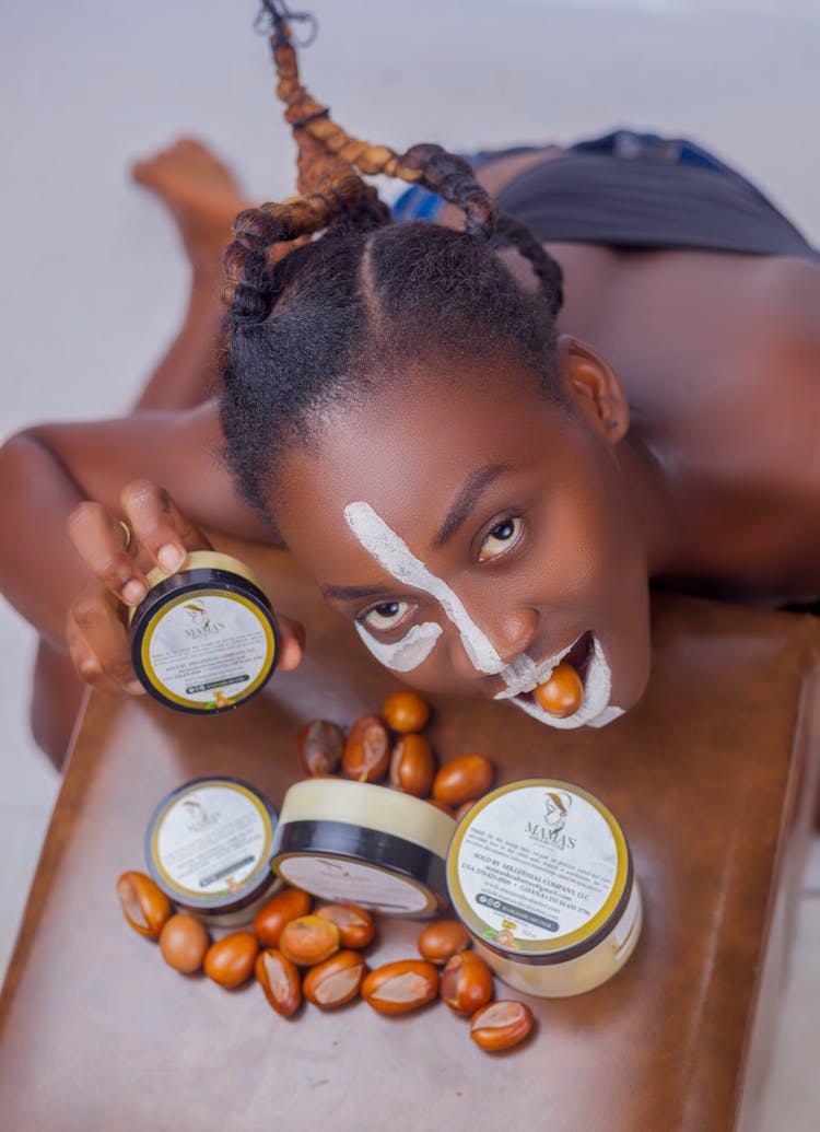 Woman Posing While Biting A Shea Nut 