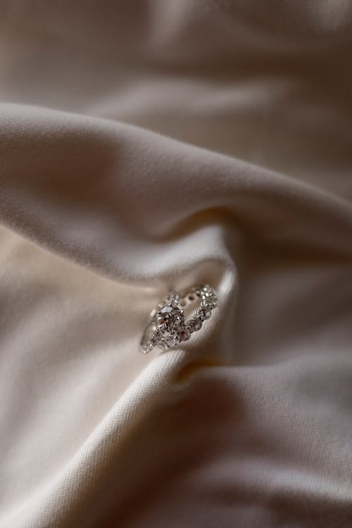 Free Diamond Ring on Beige Fabric Stock Photo