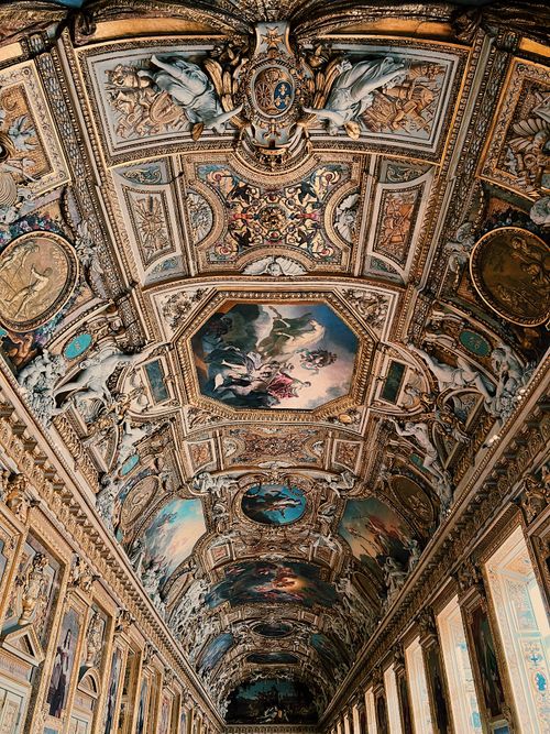 Free Stunning ceiling artwork in the Louvre Museum, showcasing Baroque style and rich cultural heritage. Stock Photo