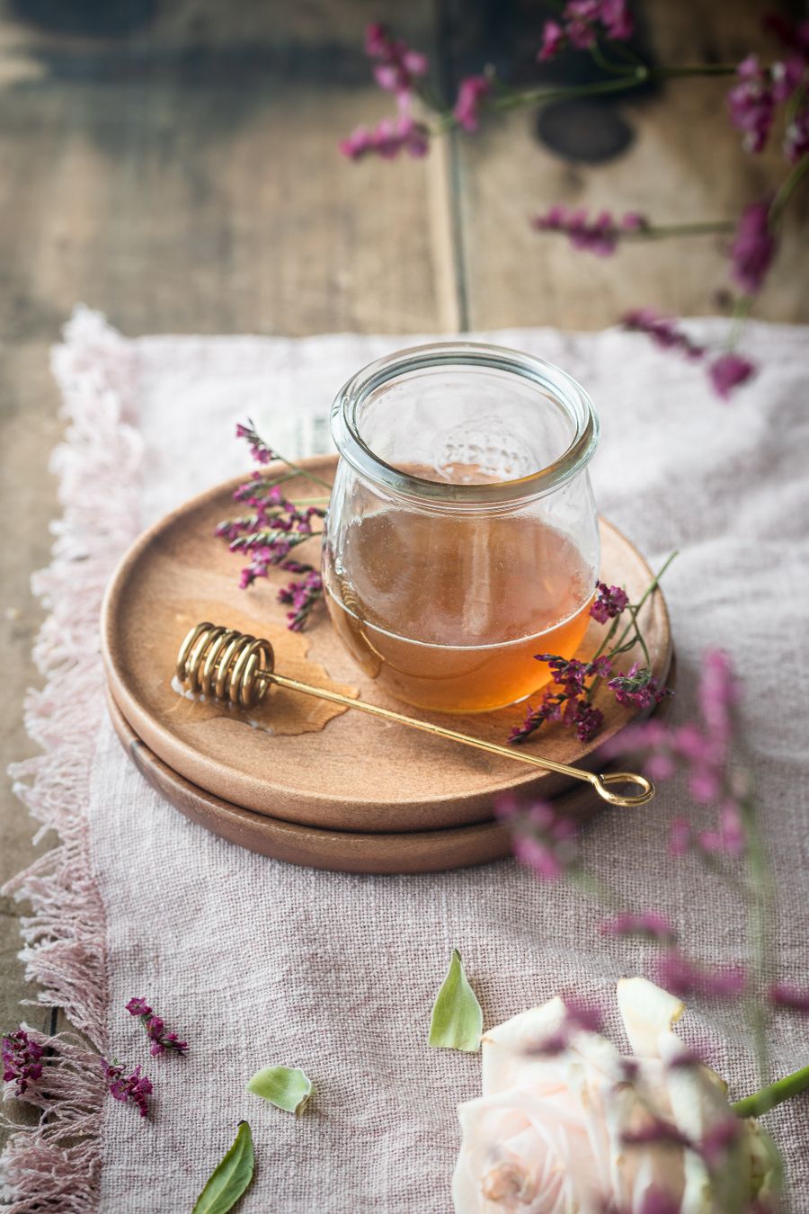 Warm cup of herbal chai tea with cinnamon stick garnish on a rustic wooden table — the kind of everyday herbal chai enjoyed across India from Andhra Pradesh to Punjab