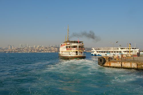 Free A ferry boat cruising on the Bosphorus Strait in İstanbul, Türkiye with city skyline in the background. Stock Photo