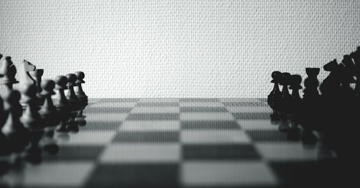 Black and White Chessboard Set Near White Wall