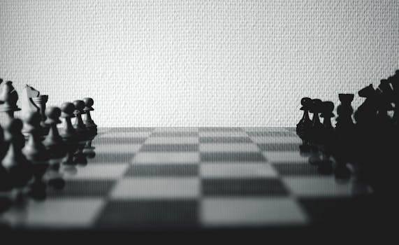 Black and white chess pieces set up on a board, highlighting strategic gameplay.