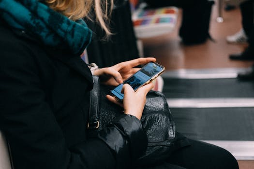 A woman uses her smartphone while commuting on public transportation.