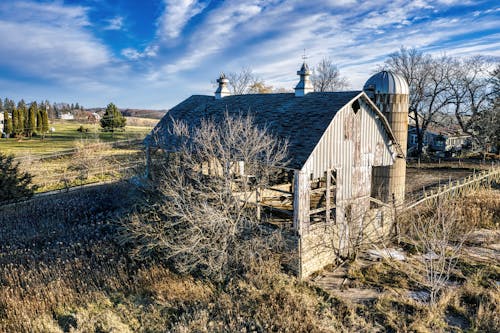 Abandoned Broken House on Green Grass Field 