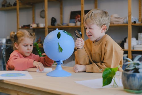 Boy Looking at a Leaf using a Magnifying Glass