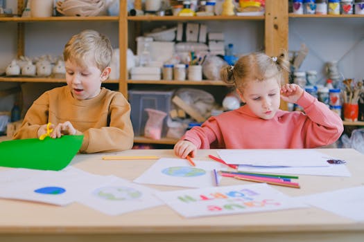 Two children engaged in arts and crafts in a classroom setting, focusing on creativity and learning.