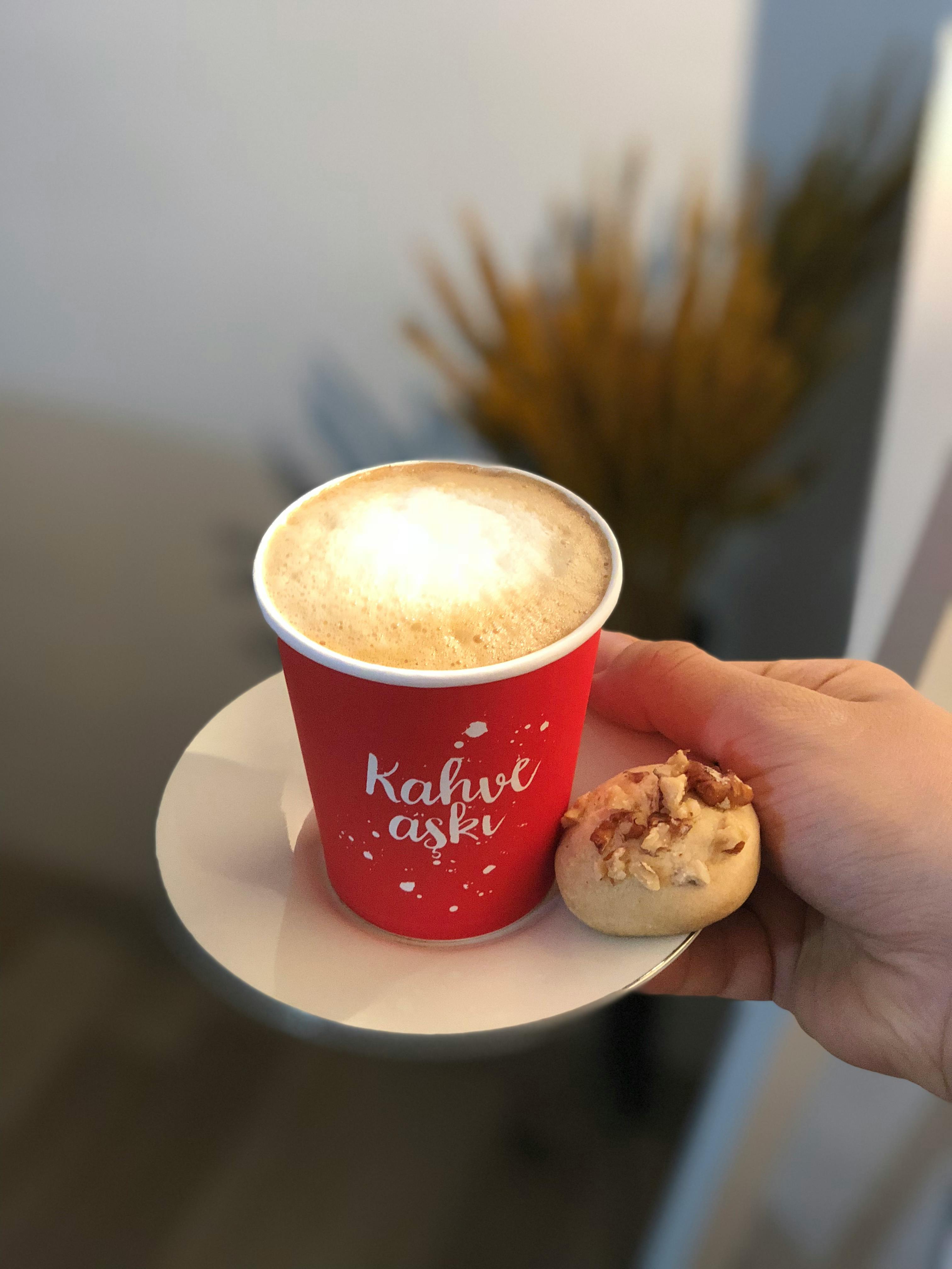 A Woman Walking with her Bicycle while Holding a Coffee Paper Cup ...