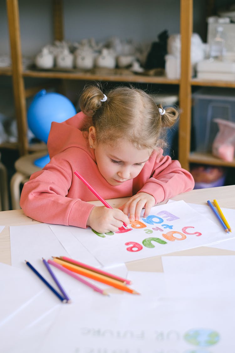 A Girl Coloring A White Paper