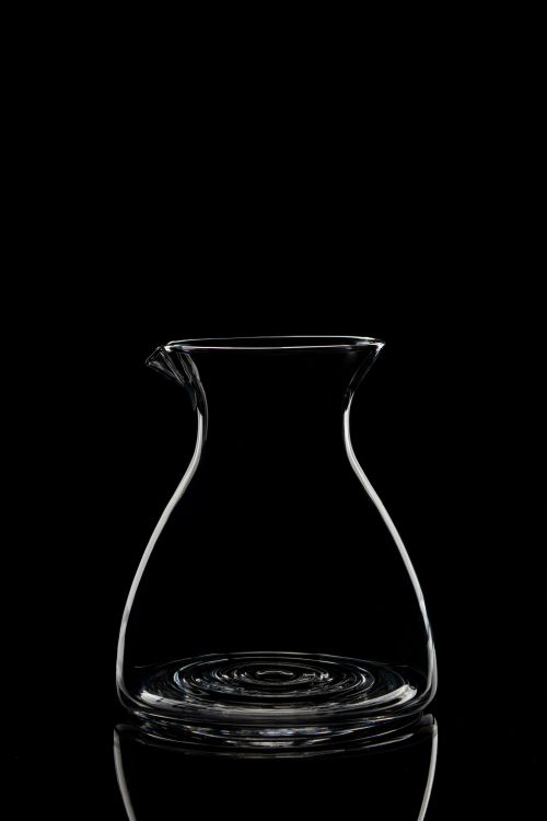 Free Stylish clear glass decanter on a black background, perfect for minimalistic settings. Stock Photo