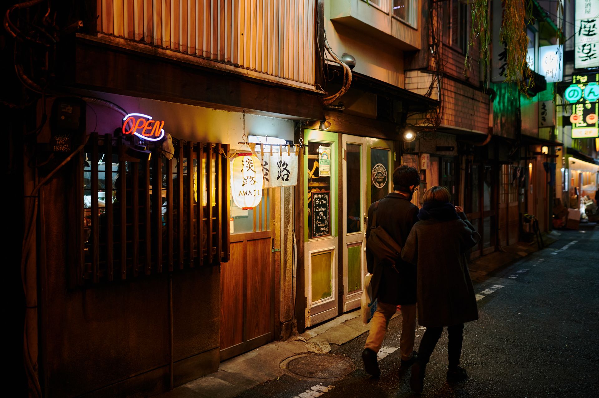 Couple Walking Past a Restaurant