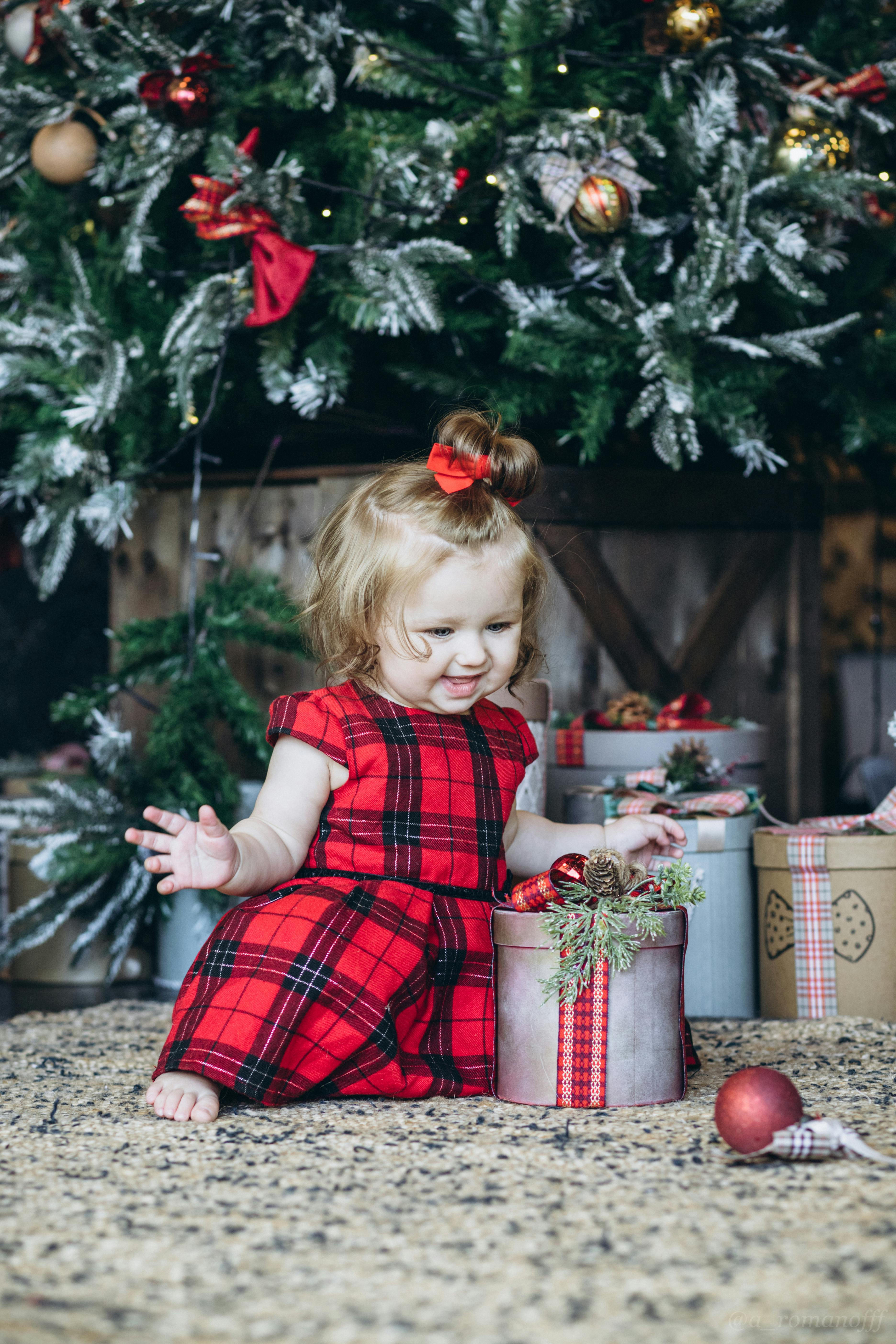 A Baby in Red Dress with a Gift · Free Stock Photo