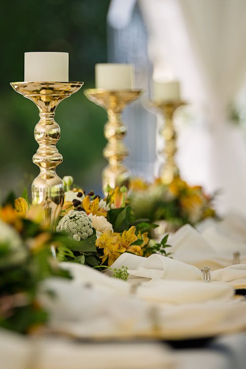 Selective Focus Photography of Gold Candlestick on Table