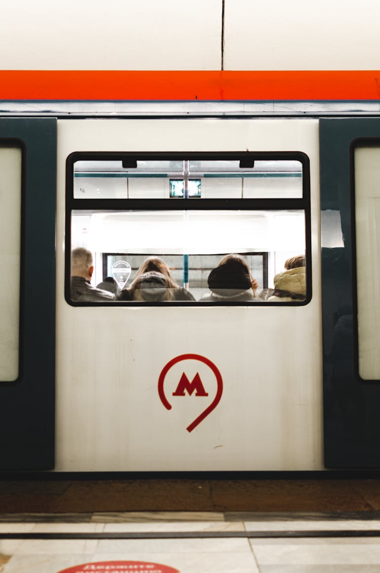 Back View Of People Riding A Train