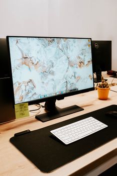 A sleek office desk setup with a monitor, keyboard, mouse, and potted plant for a modern work environment.. pexels, sleek, of