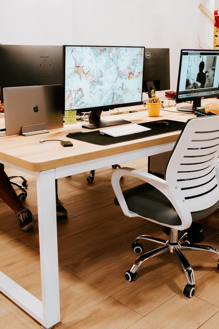 Black Flat Screen Computer Monitors On Brown Wooden Desk