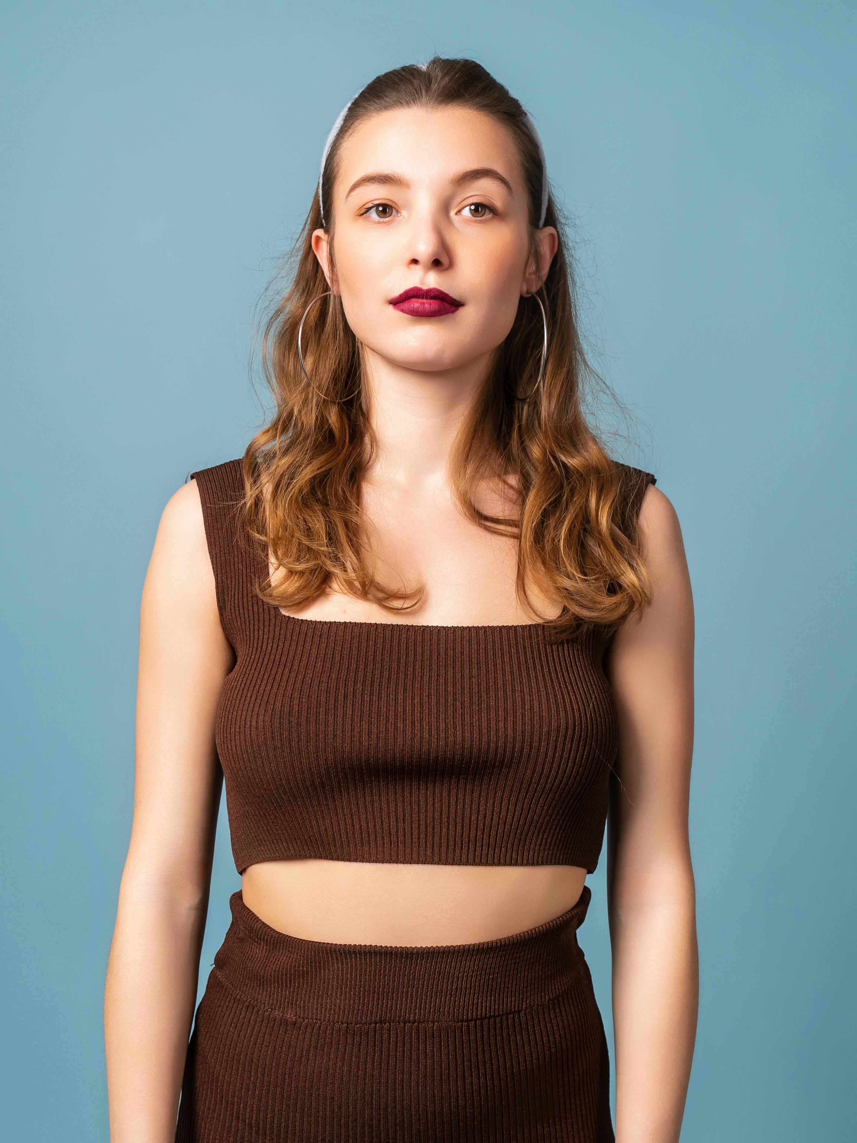 A model wears earrings, a necklace, a green knit crop top with a... News  Photo - Getty Images